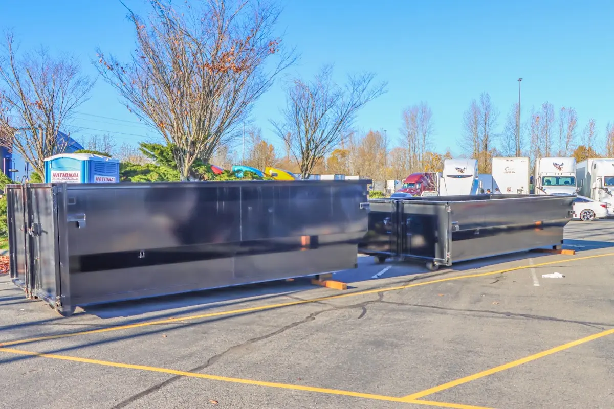 Professional dumpster rental service with roll-off container on residential driveway in Oswego